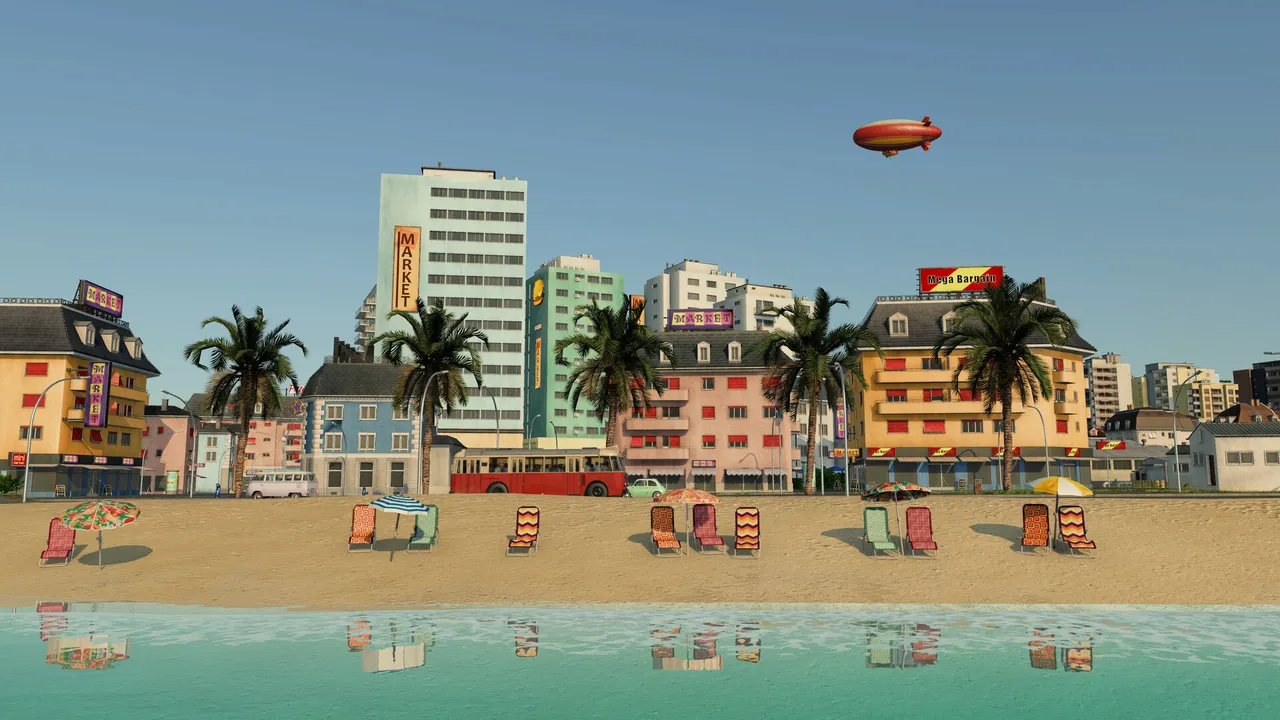 Colourful seaside hotels behind a sandy beach with parasols, an airship in the sky