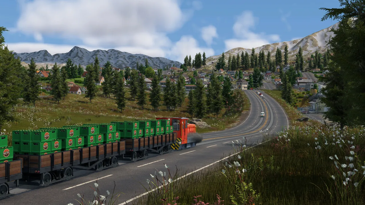 A diesel locomotive pulling open wagons loaded with green crates along a road through pine forest