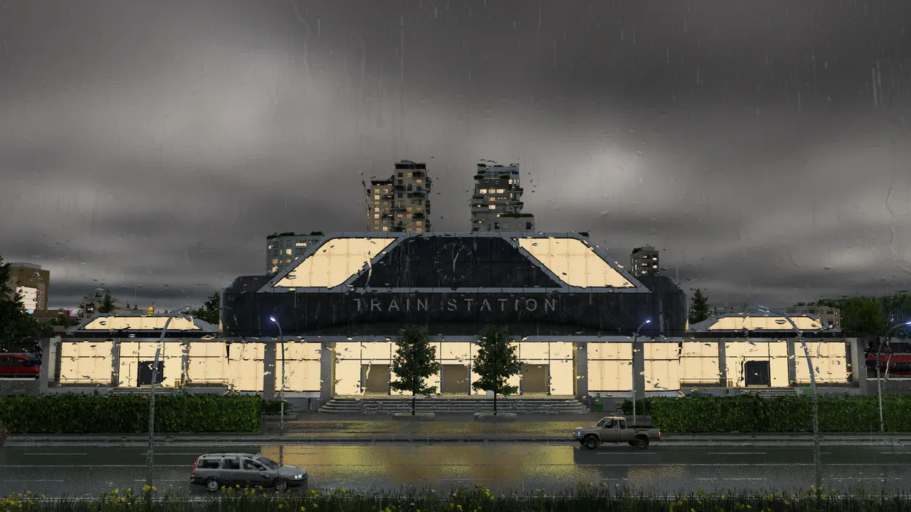 A large train station building lit up under dark rain clouds, cars passing in front